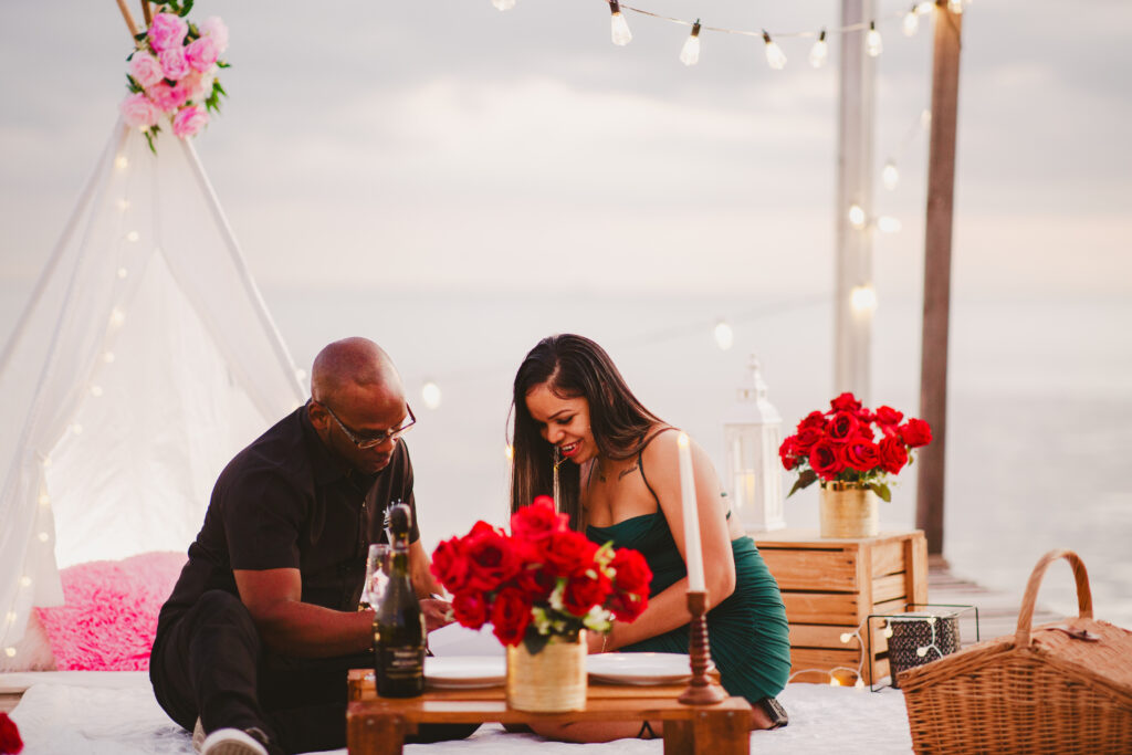 Couple reading love note at romantic picnic in Trinidad and Tobago